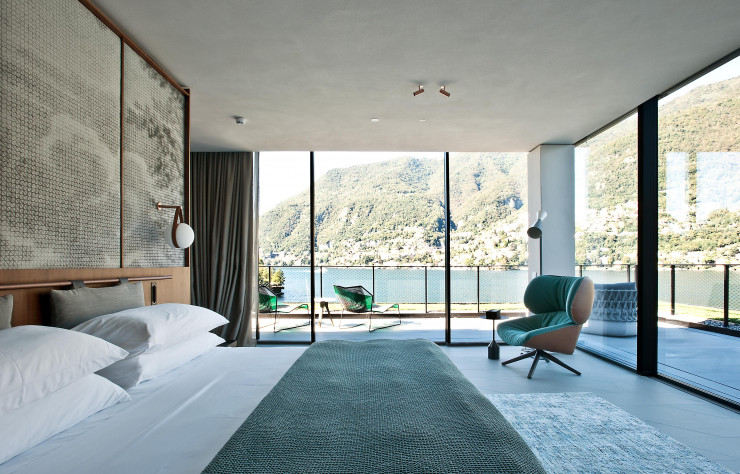 A travers la baie vitrée, on aperçoit, à gauche, la chaise longue « Tropicalia » (Moroso) et, à droite, le sofa outdoor « Fat » (B&B Italia). Fauteuil pivotant « Tabano » (B&B Italia) et table d’appoint « Burin » (Viccarbe) : un mobilier signé Patricia Urquiola.
