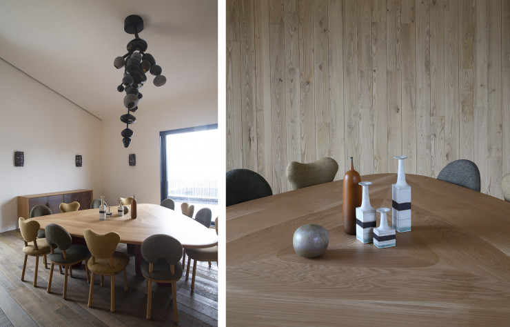 La salle à manger du chai affirme son chic singulier avec une table en chêne et céramique, des chaises « Monsieur » et « Mademoiselle Oops ». Suspension en verre soufflé et métal.