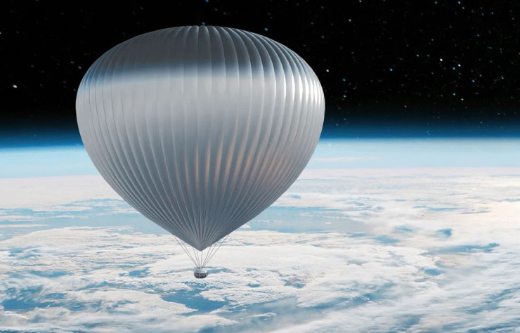 La capsule est reliée à un immense ballon qui se fond dans le décor.