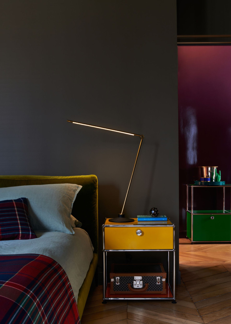Dans la chambre principale, d’un brun chaud Drab 290 (Farrow&Ball), lit réalisé sur mesure (The Conran Shop), lampe Thin Task, design Peter Bristol/ Juniper (Triode), posée sur une table de chevet USM Haller M54. En arrière-plan, dans le couloir couleur aubergine, se détache un meuble vert USM Haller.